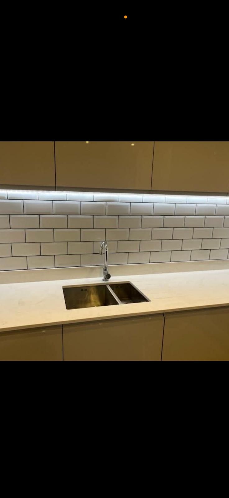 Kitchen with white metro tile splashback